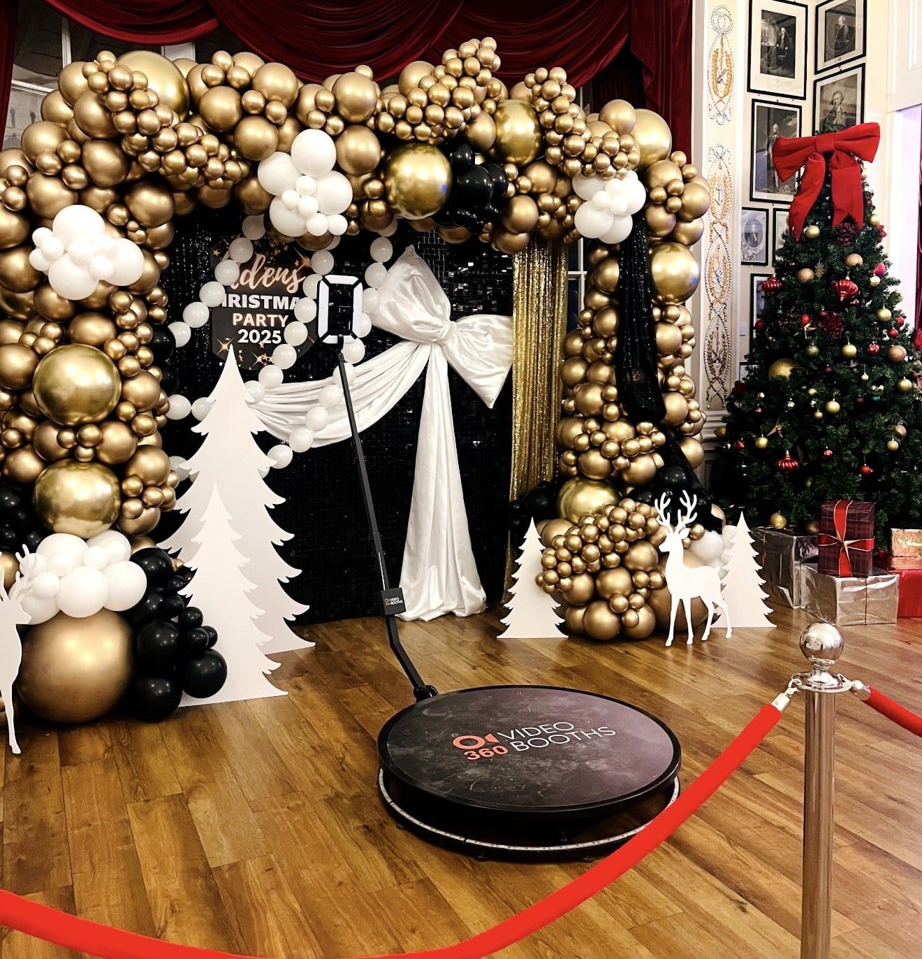 360 video booth with red carpet and rope stanchions at a Christmas party